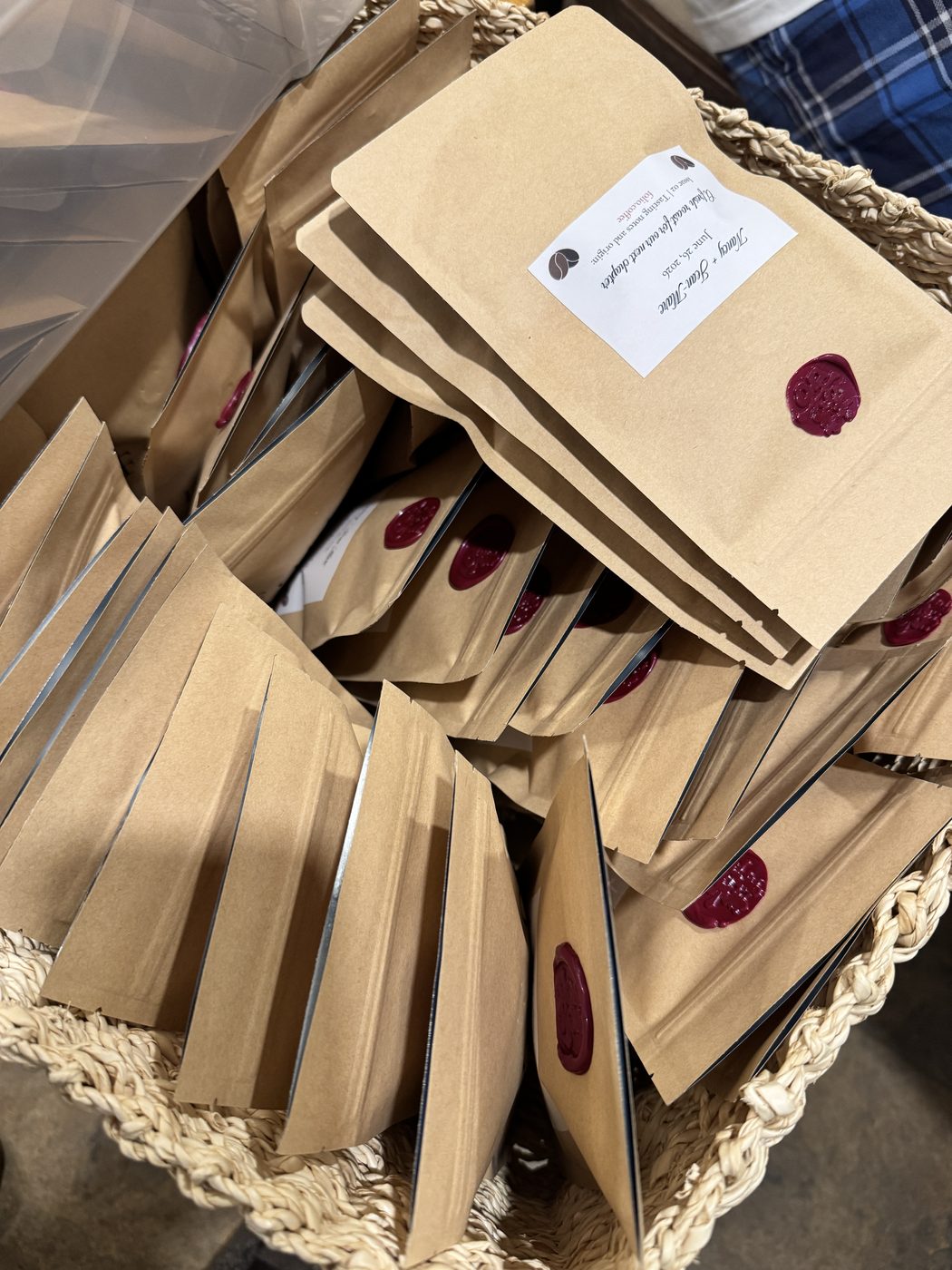 A basket of Folio wedding favor bags, each with a wax seal