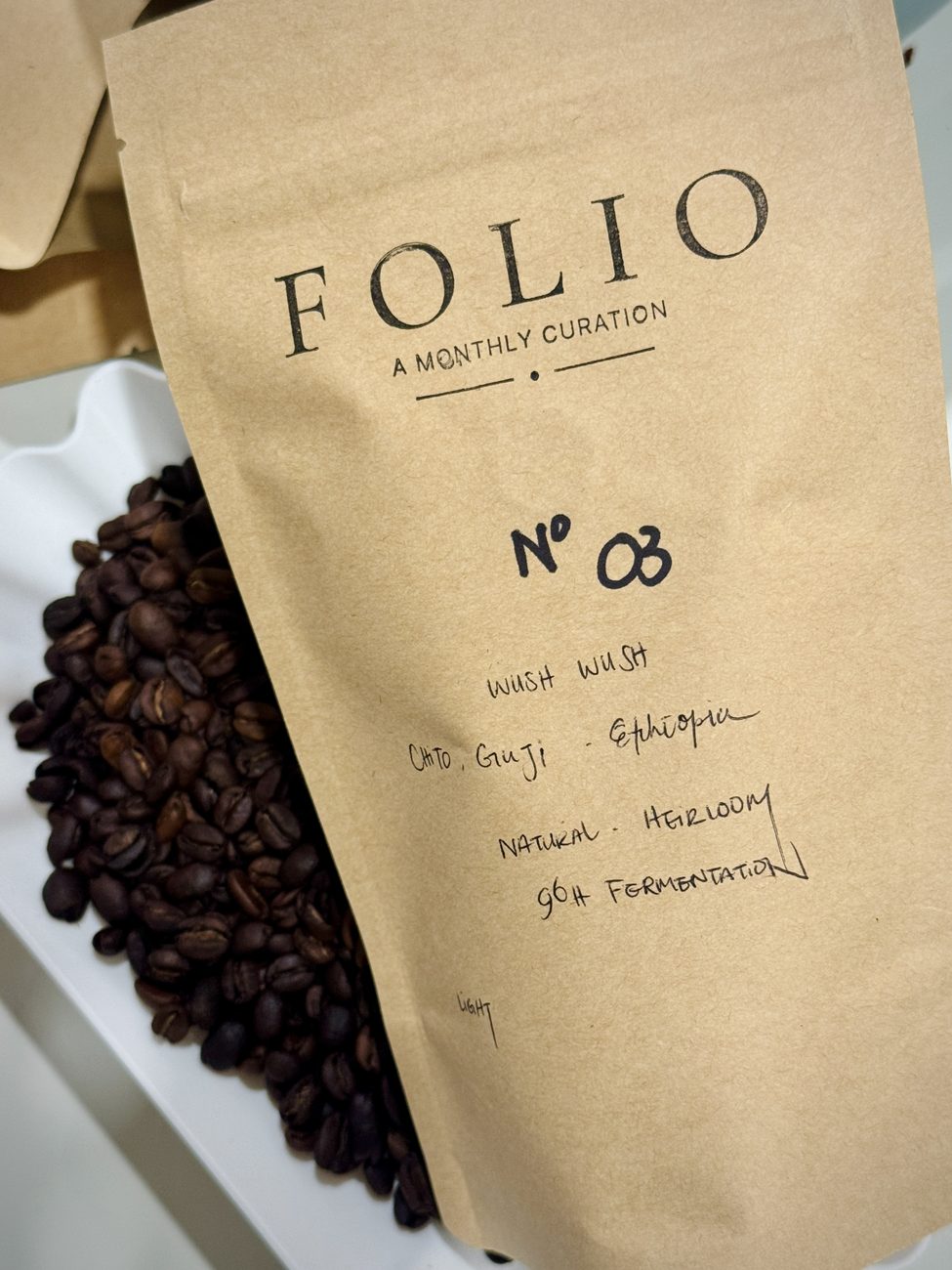 The Folio Nº 03 bag, Ethiopia Wush Wush, beside roasted beans