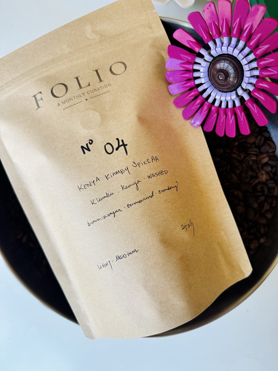 The Folio Nº 04 bag, Kenya Kiambu Spike AA, beside roasted beans